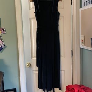 Black satin like Calvin Klein jumpsuit with pockets and a tie belt